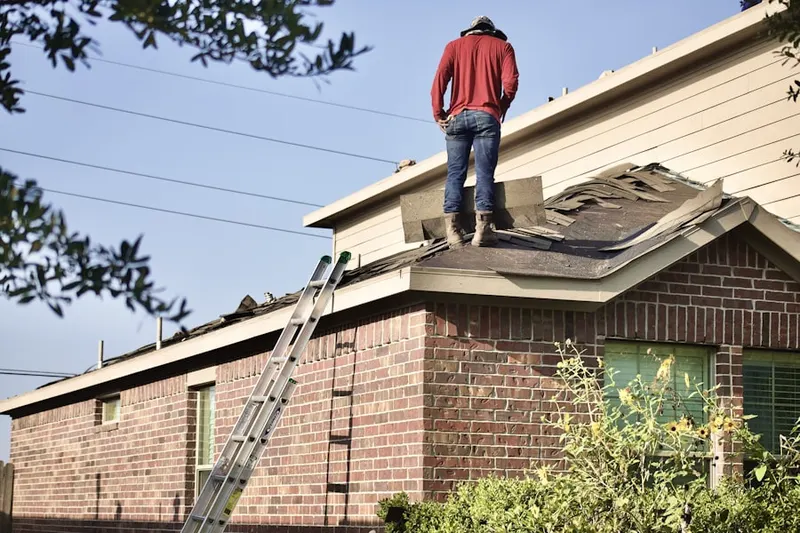Professional roofer working on a residential roof in Redwood
